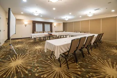 a conference room with tables and chairs in it at Hampton Inn Tiffin in Tiffin