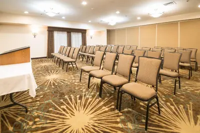 a room with rows of chairs and a podium at Hampton Inn Tiffin in Tiffin