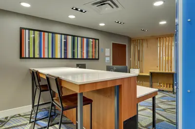 an office with a counter and chairs in a room at Holiday Inn Express & Suites Troy by IHG in Troy