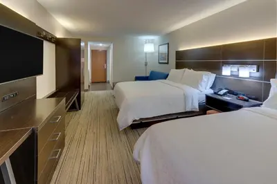 a hotel room with two beds and a flat screen tv at Holiday Inn Express & Suites Troy by IHG in Troy