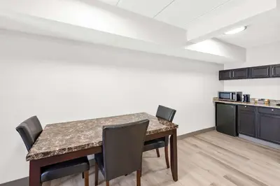a dining room with a table and chairs at Comfort Suites Columbus in Columbus