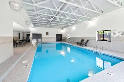 a large pool with blue water in a building at Comfort Suites Columbus in Columbus