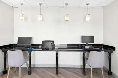 a desk with two computers and two chairs at Comfort Suites Columbus in Columbus