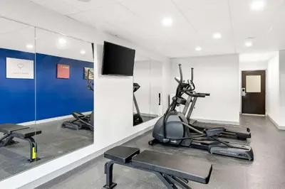 a gym with two exercise bikes and a flat screen tv at Comfort Suites Columbus in Columbus