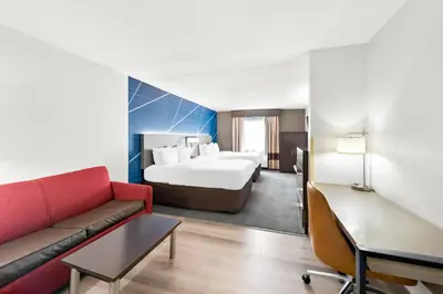 a hotel room with a bed and a couch at Comfort Suites Columbus in Columbus