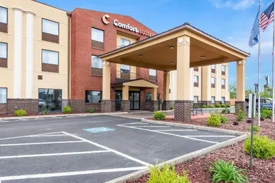 a front view of a hotel with a parking lot at Comfort Suites Columbus in Columbus