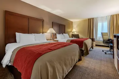 a hotel room with two beds and a window at Comfort Inn Warren I-69 in Warren