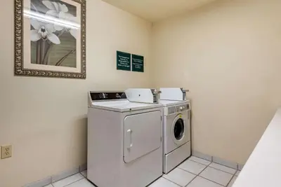a washer and dryer in a room at Comfort Inn Warren I-69 in Warren