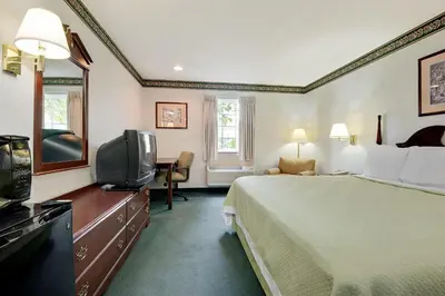 a hotel room with a bed and a television at Days Inn by Wyndham Lisbon in Lisbon