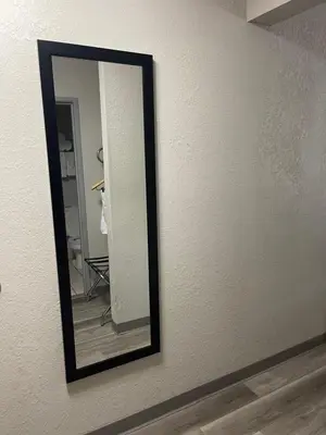 a mirror hanging on a wall in a room at Days Inn by Wyndham Lisbon in Lisbon