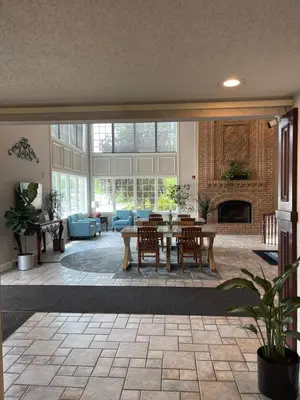 a large living room with a table and a fireplace at Days Inn by Wyndham Lisbon in Lisbon