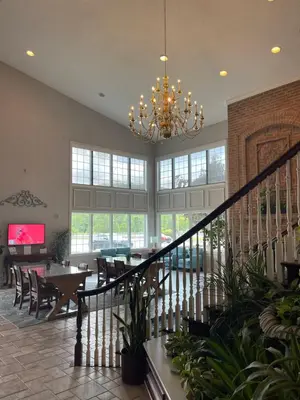 a dining room with a chandelier and a table and chairs at Days Inn by Wyndham Lisbon in Lisbon