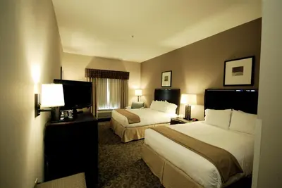 a hotel room with two beds and a flat screen tv at Holiday Inn Express Hotel & Suites Van Wert by IHG in Van Wert
