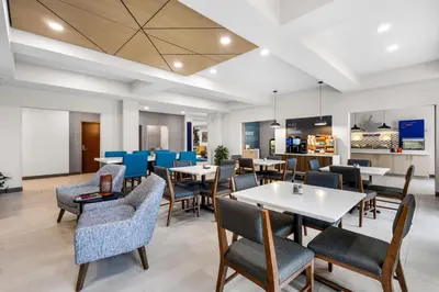a dining room with tables and chairs at Holiday Inn Express Hotel & Suites Van Wert by IHG in Van Wert