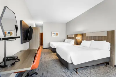 a hotel room with two beds and a desk at Holiday Inn Express Hotel & Suites Van Wert by IHG in Van Wert