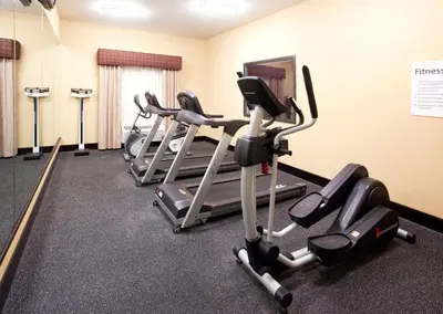 a row of exercise bikes in a gym at Holiday Inn Express Hotel & Suites Van Wert by IHG in Van Wert