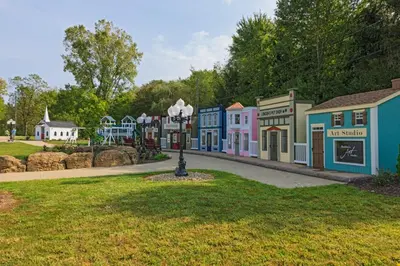 a row of colorful buildings in a park at Berlin Resort in Millersburg