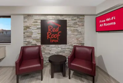 a waiting room with two chairs and a red roof sign at Red Roof Inn Mansfield in Mansfield