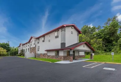 a large white building with a red roof at Red Roof Inn Mansfield in Mansfield