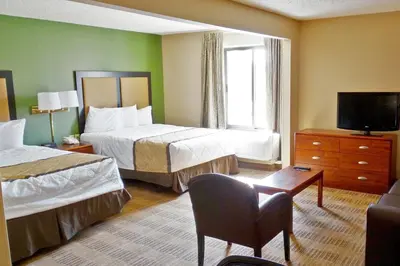 a hotel room with two beds and a television at Extended Stay America Suites - Cleveland - Middleburg Heights in Middleburg Heights