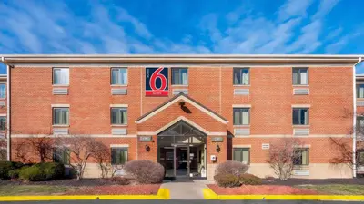 a red brick building with a sign on it at Studio 6 Extended stay Florence, KY - Meijer Dr - Cincinnati in Florence