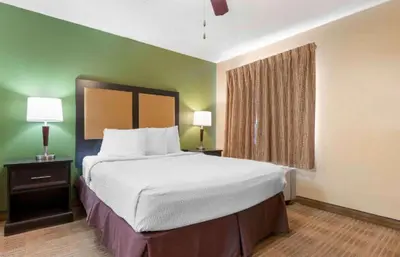 a large bed in a hotel room with two lamps at Studio 6 Extended stay Florence, KY - Meijer Dr - Cincinnati in Florence