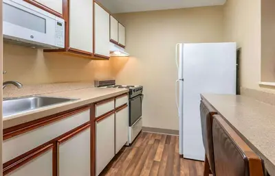 a kitchen with a white refrigerator and a sink at Studio 6 Extended stay Florence, KY - Meijer Dr - Cincinnati in Florence
