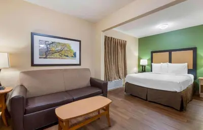 a hotel room with a bed and a couch at Studio 6 Extended stay Florence, KY - Meijer Dr - Cincinnati in Florence