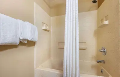 a bathroom with a tub and a shower with a shower curtain at Studio 6 Extended stay Florence, KY - Meijer Dr - Cincinnati in Florence