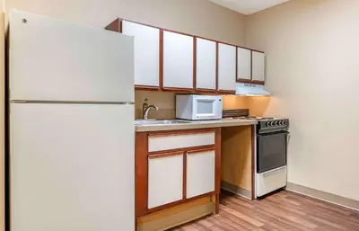 a small kitchen with a refrigerator and a microwave at Studio 6 Extended stay Florence, KY - Meijer Dr - Cincinnati in Florence