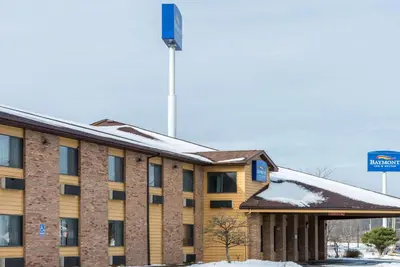 a hotel building with snow on the roof at Baymont by Wyndham Cambridge in Cambridge