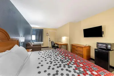 a hotel room with a bed and a flat screen tv at Econo Lodge Erlanger - Cincinnati Airport in Erlanger
