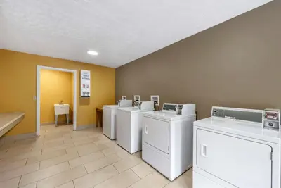 a row of washers and dryers in a laundry room at Econo Lodge Erlanger - Cincinnati Airport in Erlanger