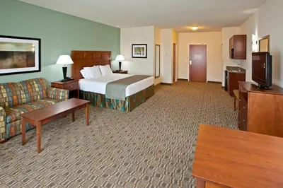 a hotel room with a bed and a couch at Holiday Inn Express & Suites Ripley by IHG in Ripley