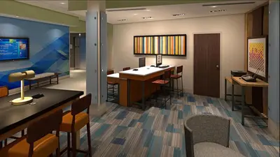 a room with a bar and some chairs and tables at Holiday Inn Express & Suites Ripley by IHG in Ripley