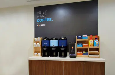 a counter with bottles of coffee on it at Holiday Inn Express & Suites Ripley by IHG in Ripley