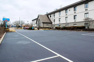an empty parking lot in front of a building at Studio Lodge - Cincinnati - Springdale in Springdale