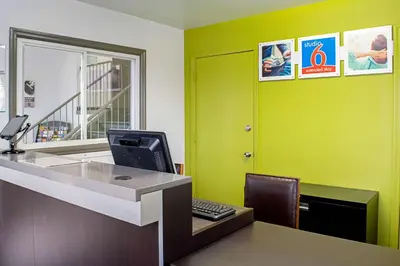 an office with green walls and a desk with a computer at Studio Lodge - Cincinnati - Springdale in Springdale