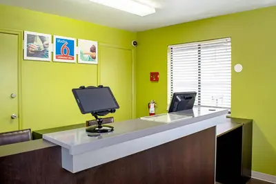 an office with a reception desk with a tv at Studio Lodge - Cincinnati - Springdale in Springdale