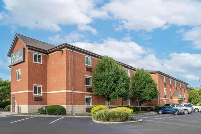a red brick building with cars parked in a parking lot at Extended Stay America Suites - Dayton - Fairborn in Dayton