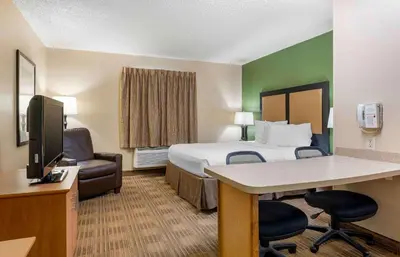 a hotel room with a bed and a desk and chair at Extended Stay America Suites - Cincinnati - Blue Ash - Reagan Hwy in Blue Ash