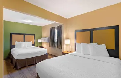 a hotel room with two beds and two windows at Extended Stay America Suites - Cincinnati - Blue Ash - Reagan Hwy in Blue Ash