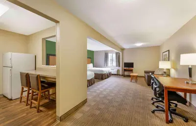 a hotel room with a bedroom with a desk and a bed at Extended Stay America Suites - Cincinnati - Blue Ash - Reagan Hwy in Blue Ash
