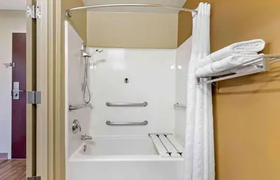 a shower in a bathroom with a white shower curtain at Extended Stay America Suites - Cincinnati - Blue Ash - Reagan Hwy in Blue Ash
