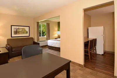 a living room with a bed and a desk in a room at Suburban Studios Columbus - Dublin in Dublin