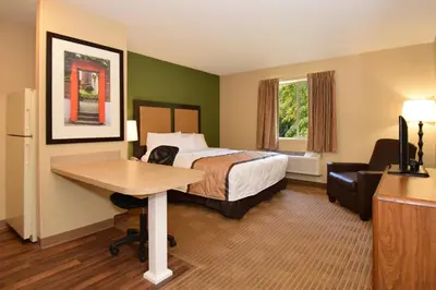 a hotel room with a bed and a desk at Suburban Studios Columbus - Dublin in Dublin
