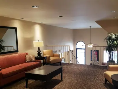 a living room with a couch and chairs and a table at Suburban Studios Columbus - Dublin in Dublin