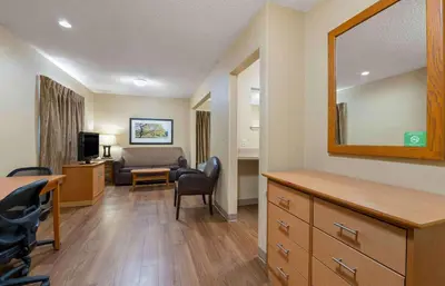 a living room with a desk and a mirror at Extended Stay America Suites - Dayton - South in Dayton