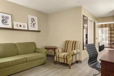a living room with a couch and a chair at Country Inn & Suites by Radisson, Lima in Lima