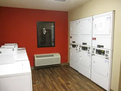a room with a room with lockers and a refrigerator at Studio 6 Extended stay Fairfield, OH - Cincinnati in Fairfield
